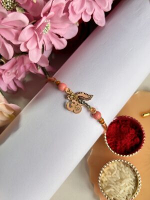 Pink om pendant rakhi design