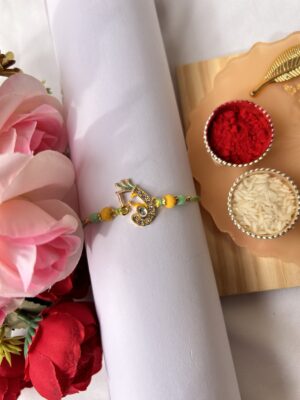 Yellow ganesha meenakari bhai rakhi